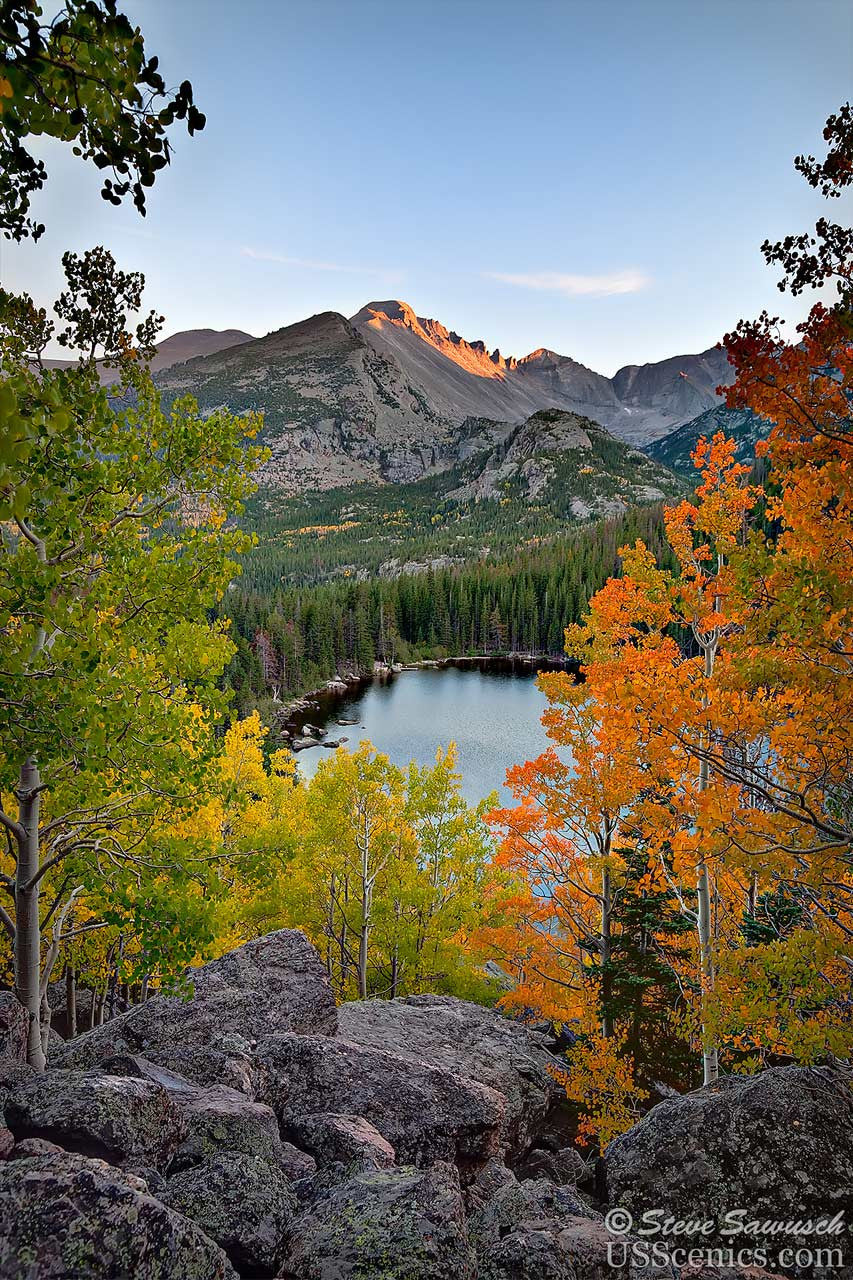 Orange, yellow and green aspens in the fall looking at Longs Peak at Bear Lake in Rocky Mountain National Park near Estes Park, Colorado