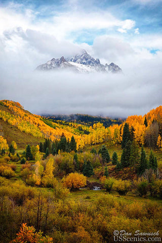mt sneffels partially covered by clouds in the fall with aspens near ridgway colorado
