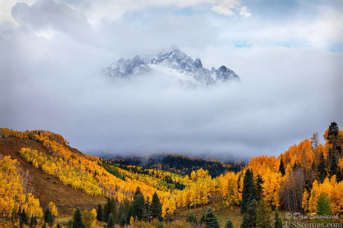 mt sneffels partially covered by clouds in the fall with aspens near ridgway colorado