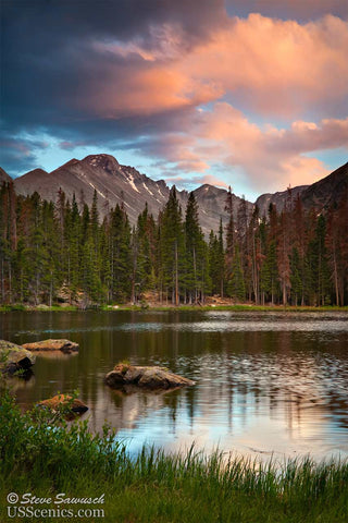 A pink summer sunset looking at Longs Peak over Nymph Lake in Rocky Mountain National Park near Estes Park, Colorado